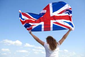 woman holding British flag in her hands